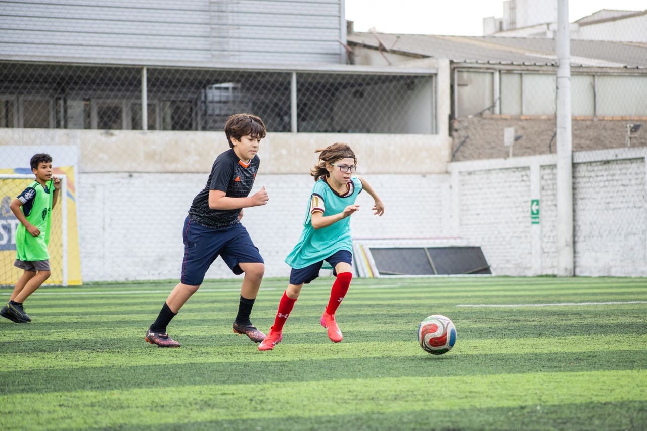 The Art of Drawing Readers In: Your attractive post title goes here Energetic kids playing soccer outdoors on a sunny day, showing teamwork and sportsmanship.
